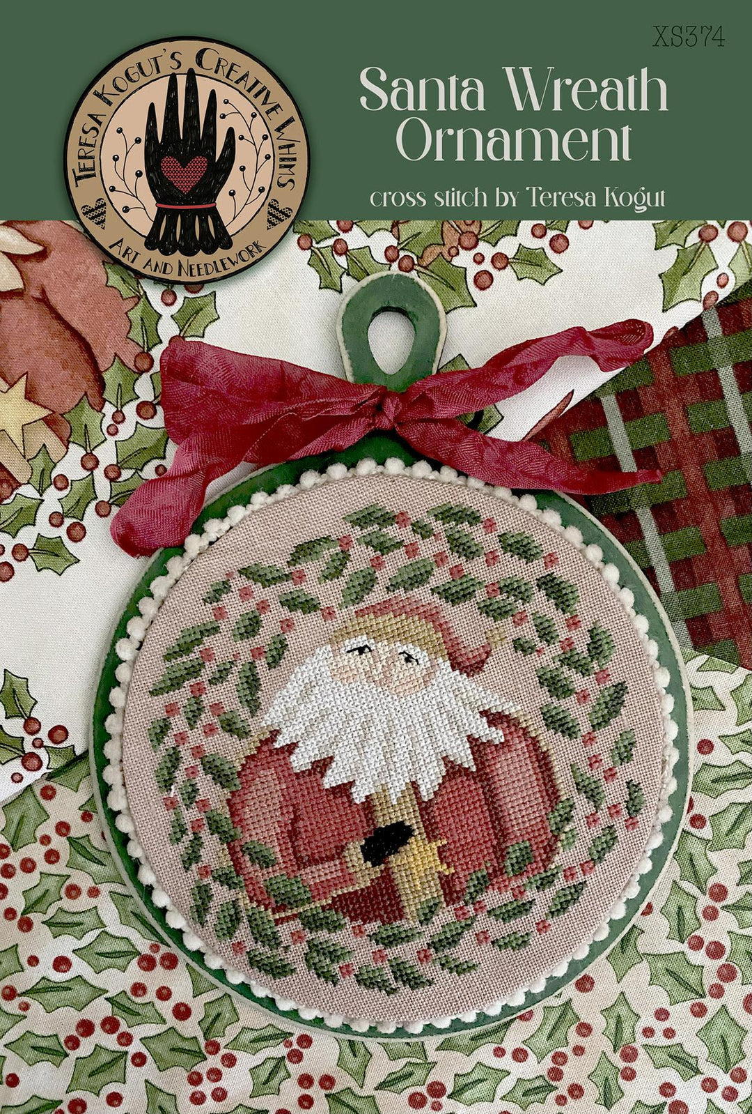 Cross-stitched Santa wreath ornament pattern with red bow and holly leaves.