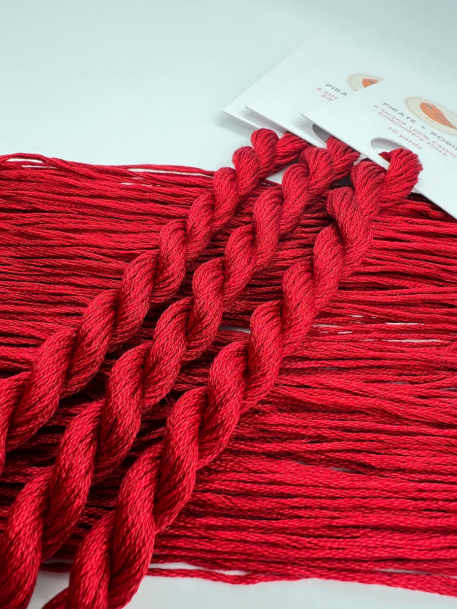 Red embroidery floss with a white label on a white background