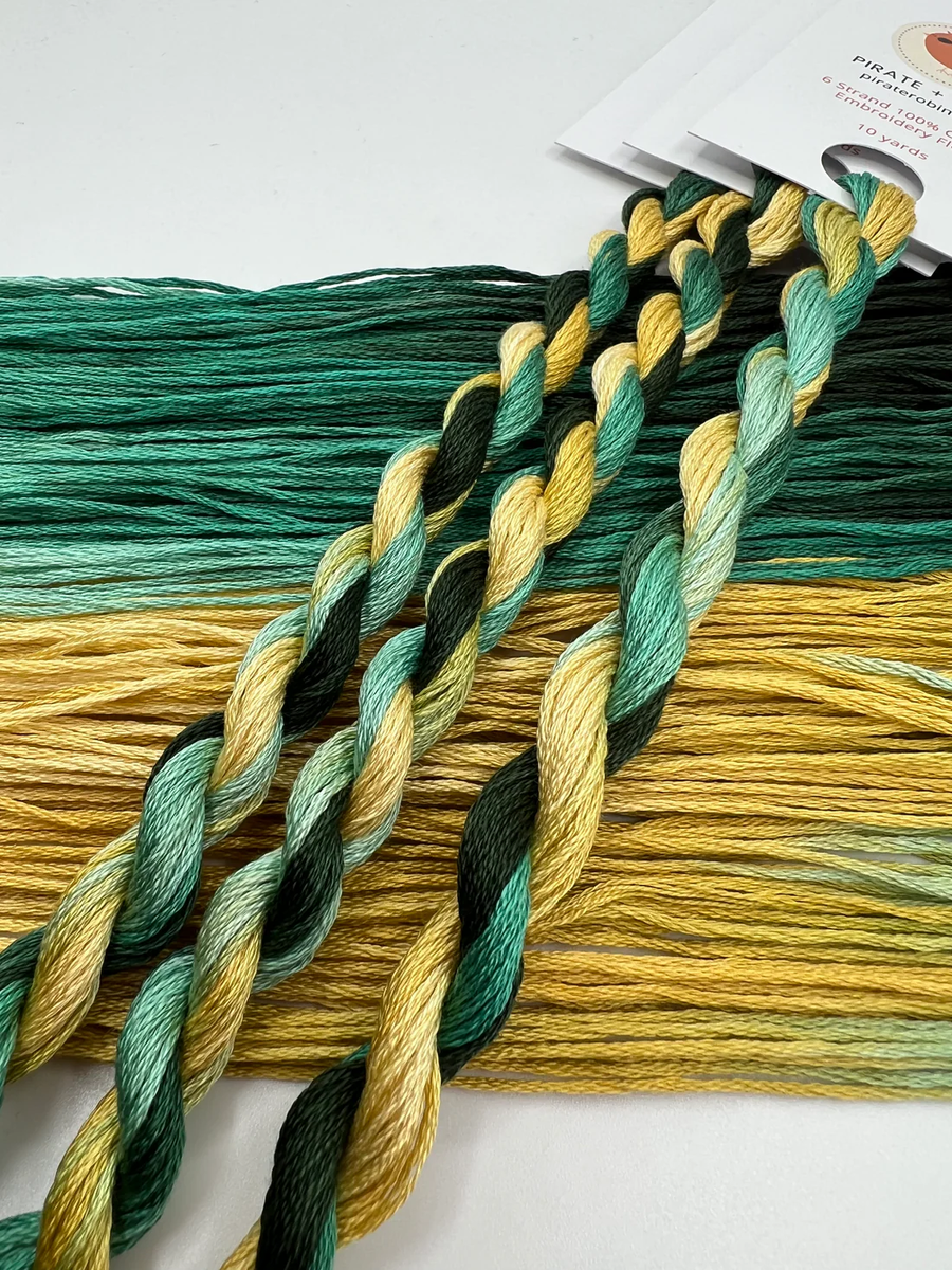 Color swatch with green and yellow embroidery floss on a white background