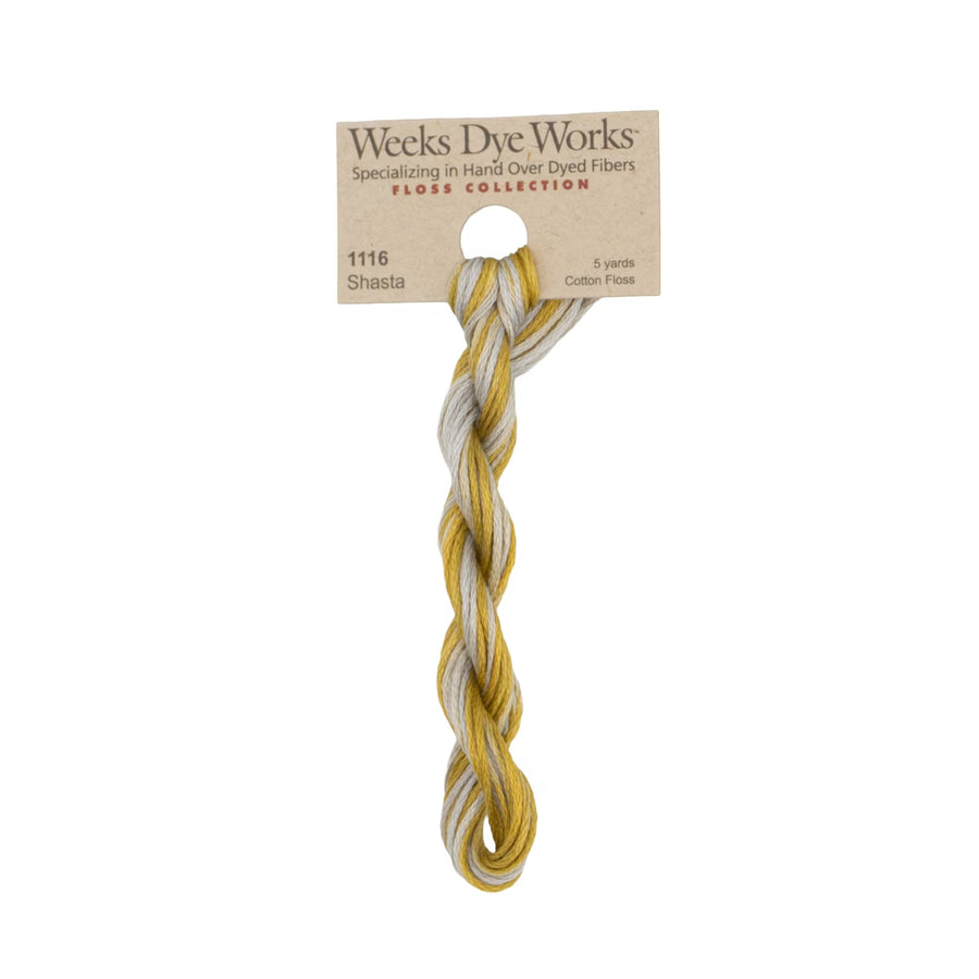 A single twisted skein of Weeks Dye Works Shasta hard overdyed cotton fiber, attached to its original kraft paper packaging card, shown against a plain white background.