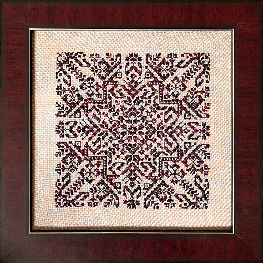 geometric design in burgundy variegated thread on light tan fabric