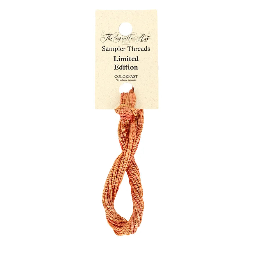 Sampler threads in peach color with a label on a white background