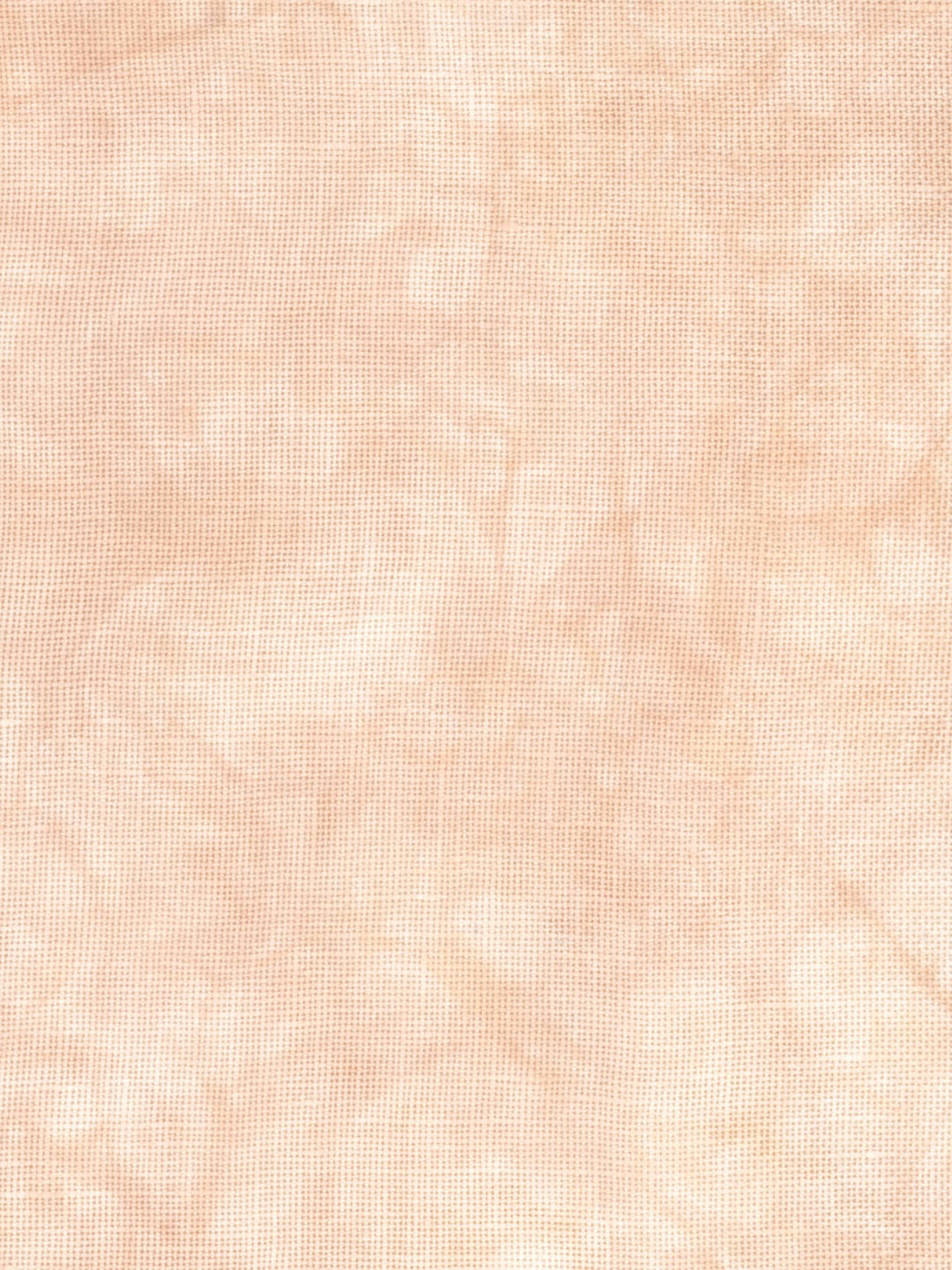 A close-up of a light peach-beige textured fabric with a subtle woven or linen-like pattern.