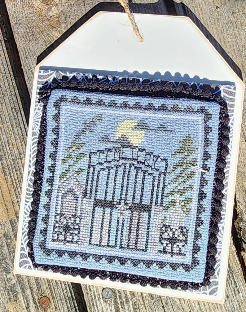 Decorative woven panel with architectural design on a wooden surface