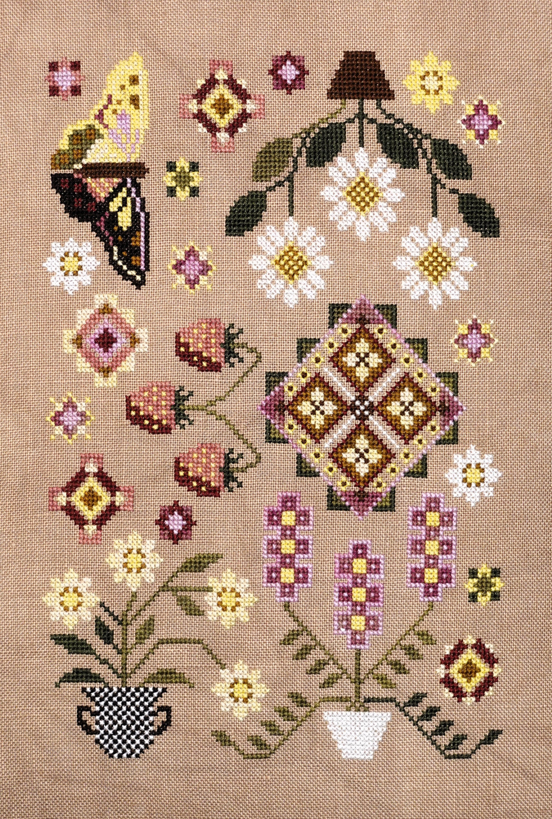 Cross-stitched pattern with flowers, butterflies, and geometric shapes on a beige background