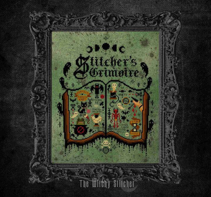 model photo fro The Witchy Stitcher stitcher's grimoire featuring a gothic cross-stitch illustration of an open book with whimsical embroidered motifs on a textured green background, framed by an ornate dark gray frame against a dark textured backdrop.