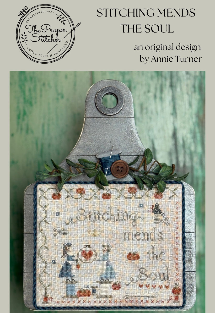 Cross-stitched design with text 'Stitching mends the soul' on a wooden hoop, branded by The Proper Stitcher.
