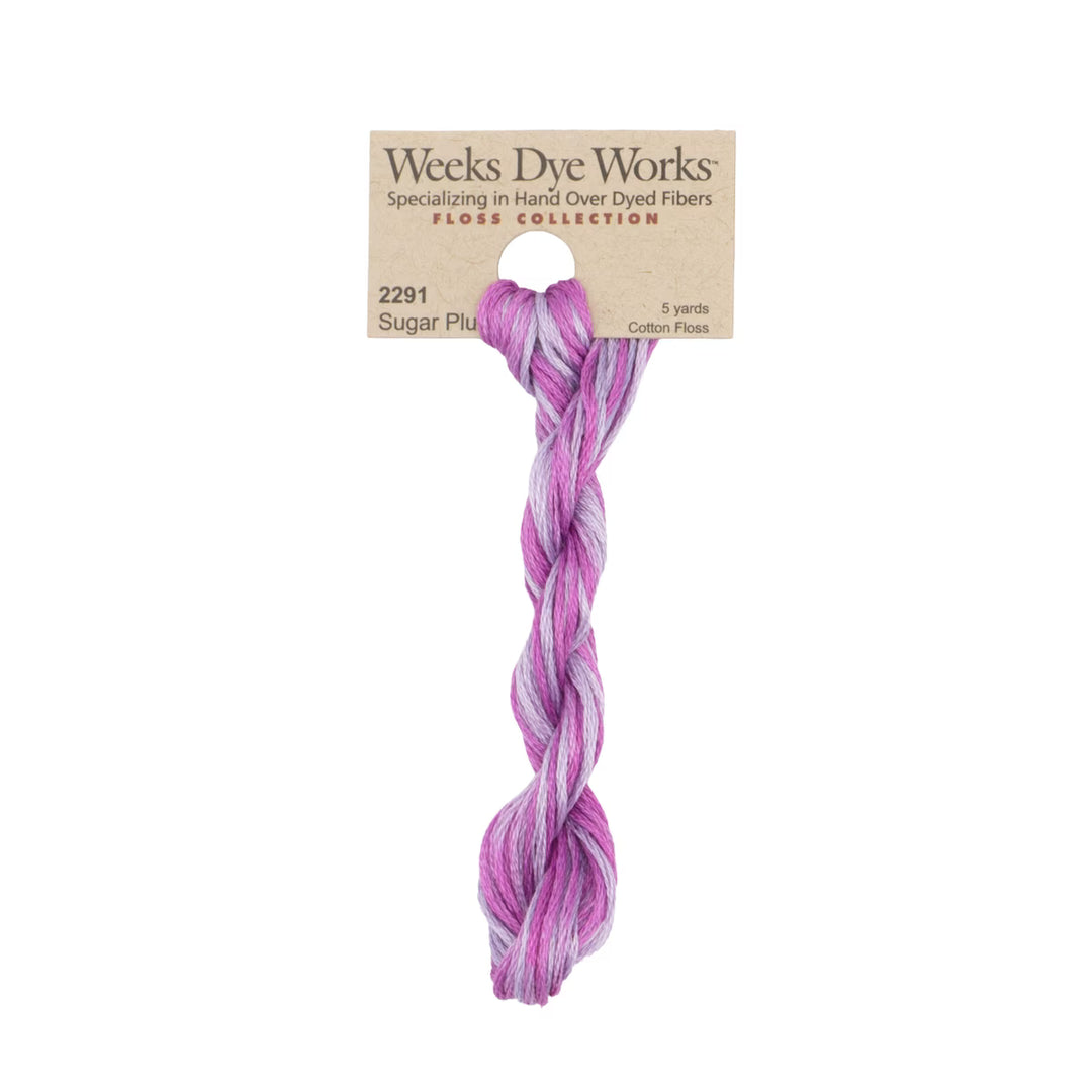 A twisted skein of Weeks Dye Works 'Floss Collection' cotton floss in the shade 'Sugar Plum', featuring a variegated pattern of purple, pink, and lavender.
