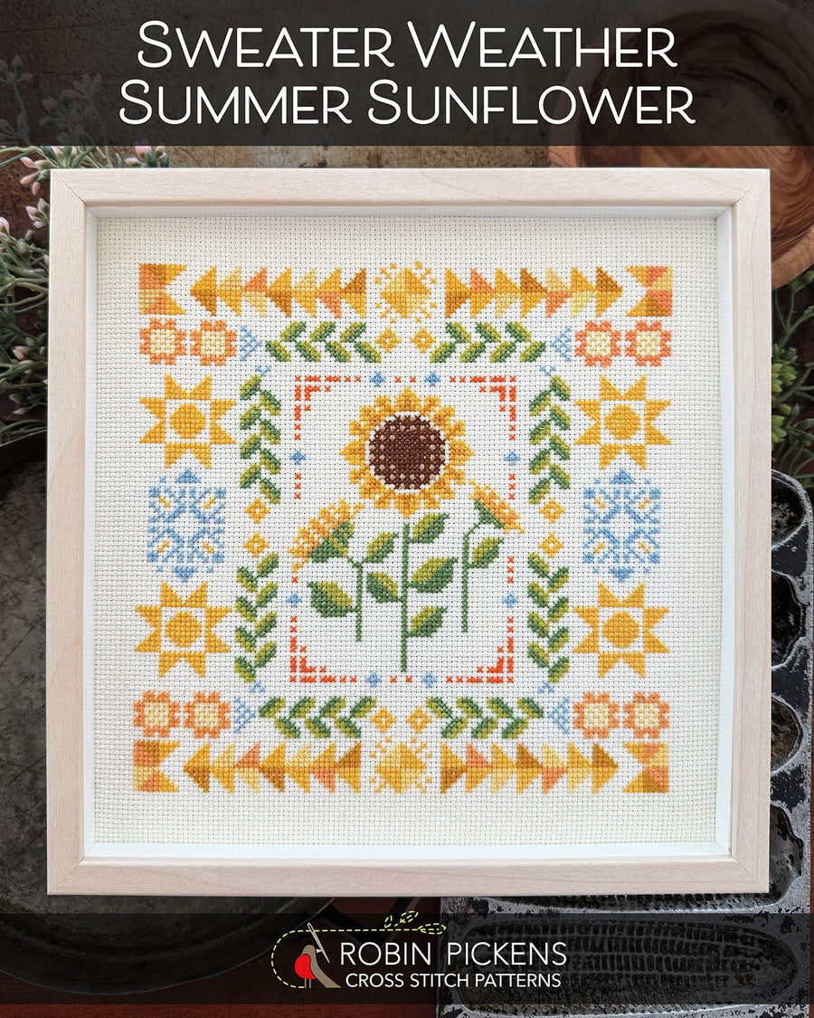 Cross-stitched pattern of sunflowers and floral designs in a wooden frame, with 'Robin Pickens Cross Stitch Patterns' branding.