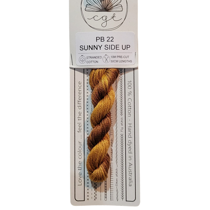 A skein of hand-dyed orange embroidery floss labeled 'Sunny Side Up' from Cottage Garden Threads.