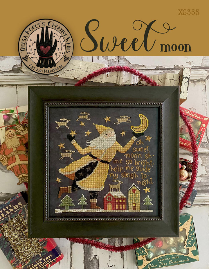 Framed cross-stitch art with a festive design, surrounded by holiday-themed decor.