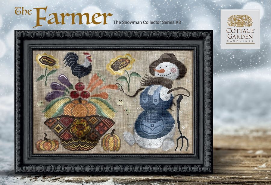 Framed cross-stitched artwork of a snowman and harvest scene with 'Cottage Garden' branding.