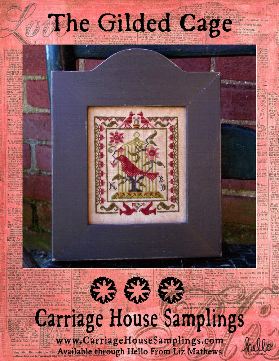 Framed cross-stitched artwork with birds on a pink background featuring 'The Gilded Cage' and 'Carriage House Samplings'.
