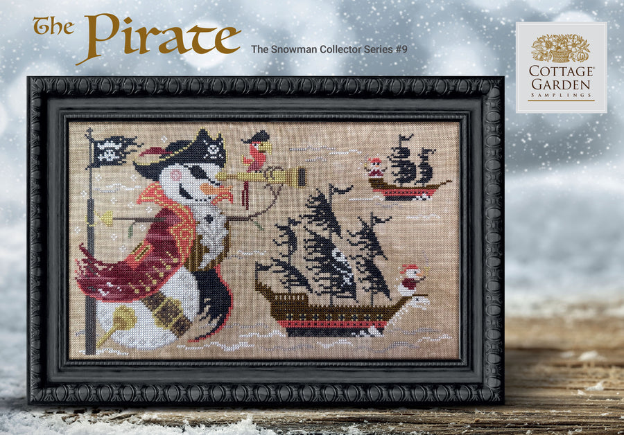 Framed cross-stitched artwork of a pirate snowman with a ship in the background, featuring the Cottage Garden Collection logo.