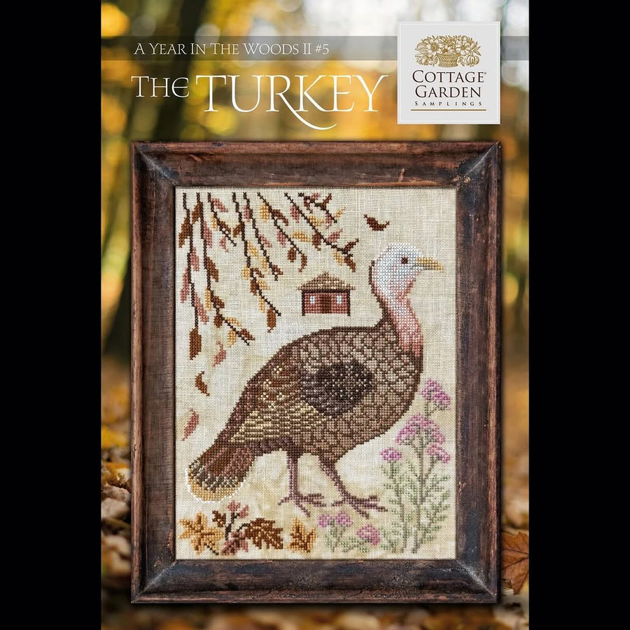 Cross-stitched turkey design with a wooden frame, featuring the Cottage Garden brand.