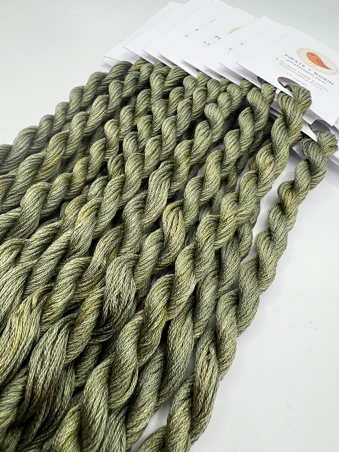 Green thread on a white background