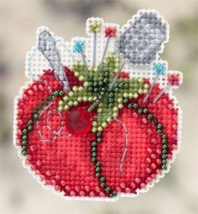 Cross-stitched design of a red tomato pincushion with green leaves and pins needles and thimble on a white background.