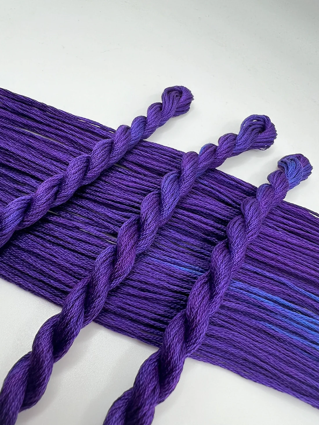 Purple braided embroidery floss  on a white background