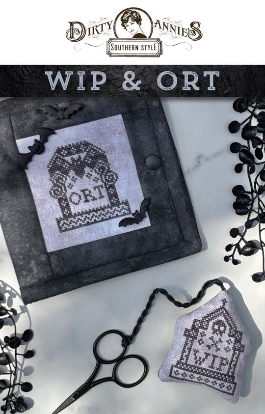Cross-stitched pieces with 'WIP' and 'ORT' on a marble surface with decorative elements.