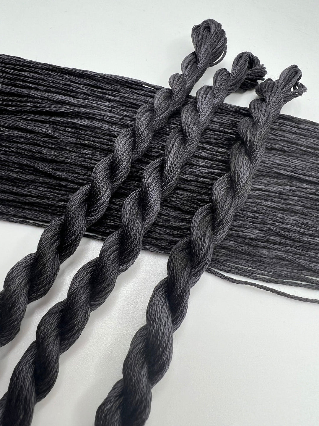 Gray braided hair extensions on a white background