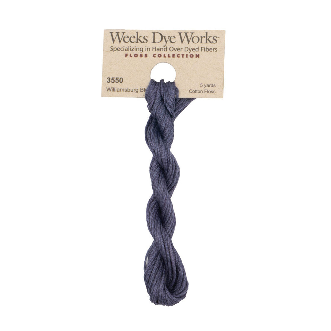 A skein of Weeks Dye Works Williamsburg Blue cotton floss thread on a kraft paper hanger, shown against a plain white background.