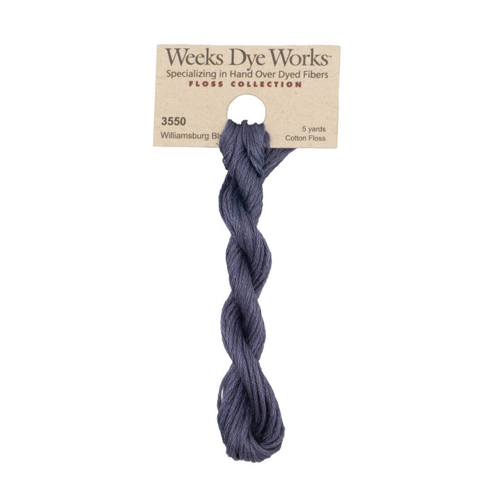 A skein of Weeks Dye Works Williamsburg Blue cotton floss thread on a kraft paper hanger, shown against a plain white background.