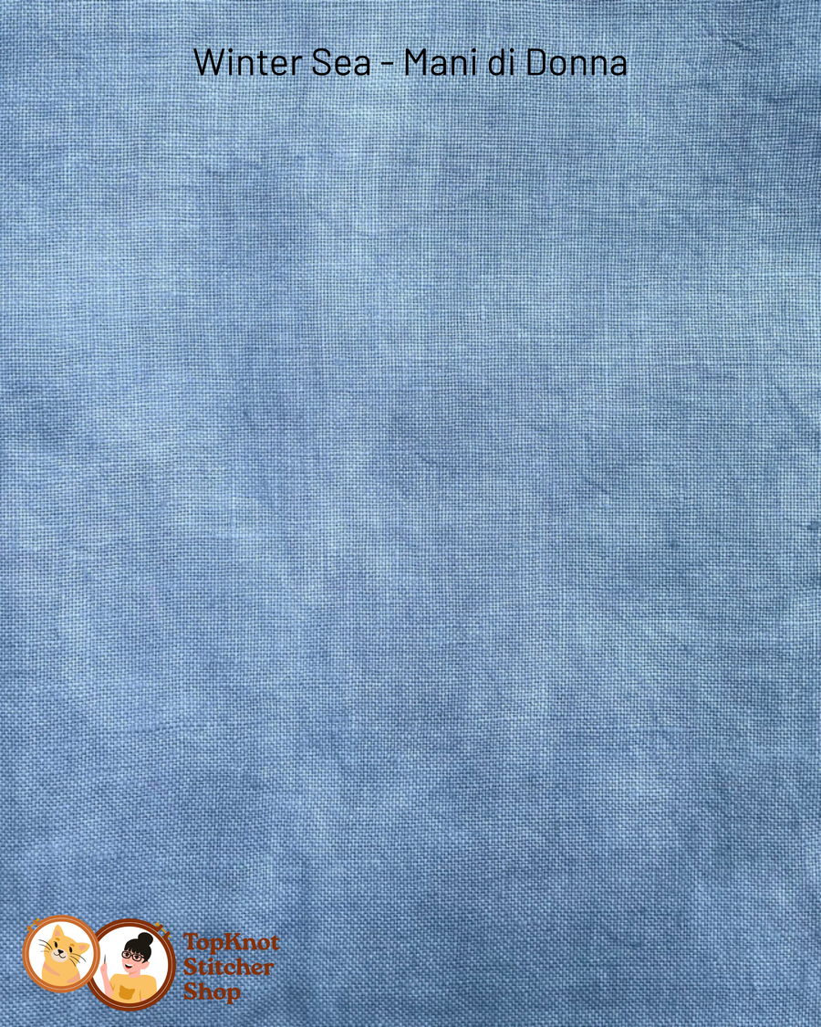 Blue fabric swatch with 'Winter Sea - Mani di Donna' text and Top Knot Stitcher Shop logo.