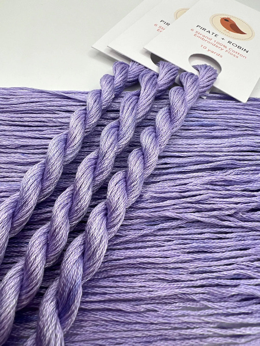 Purple embroidery floss with a brand label on a white background