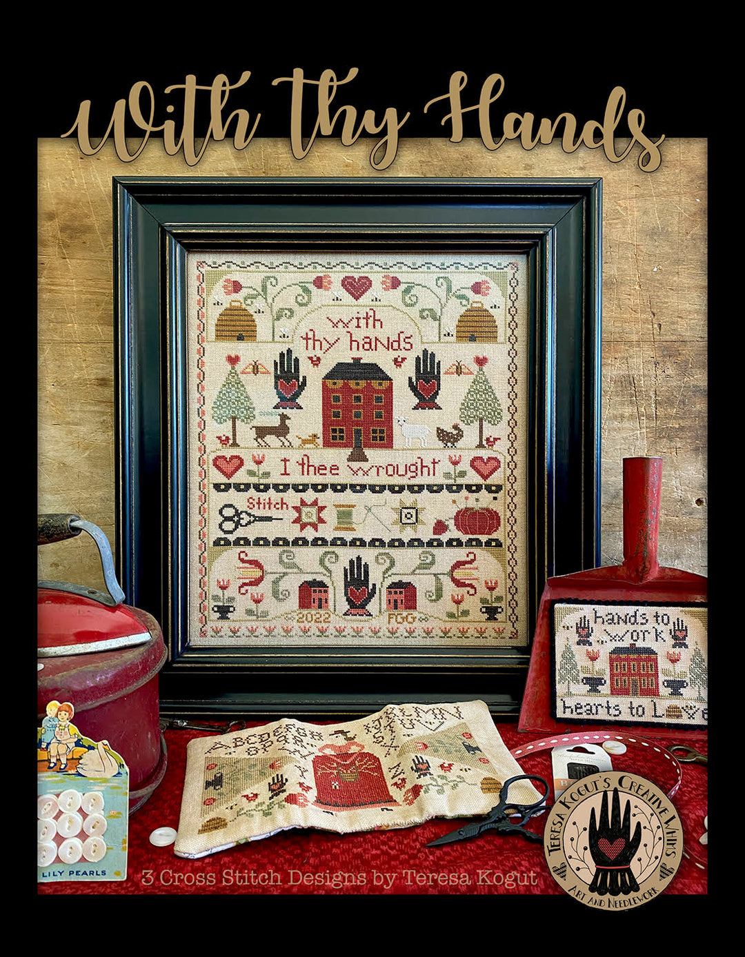 Framed cross-stitch pattern with decorative items on a wooden background