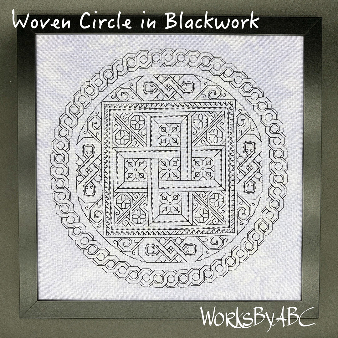 A framed blackwork design titled 'Woven Circle in Blackwork' showing a circular Celtic knot pattern on white fabric. The frame is dark gray, and the brand name 'WorksByABC' is visible in the bottom right corner.