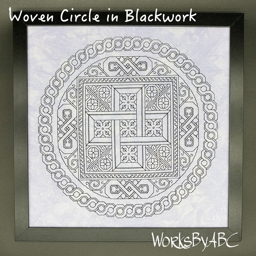 A framed blackwork design titled 'Woven Circle in Blackwork' showing a circular Celtic knot pattern on white fabric. The frame is dark gray, and the brand name 'WorksByABC' is visible in the bottom right corner.