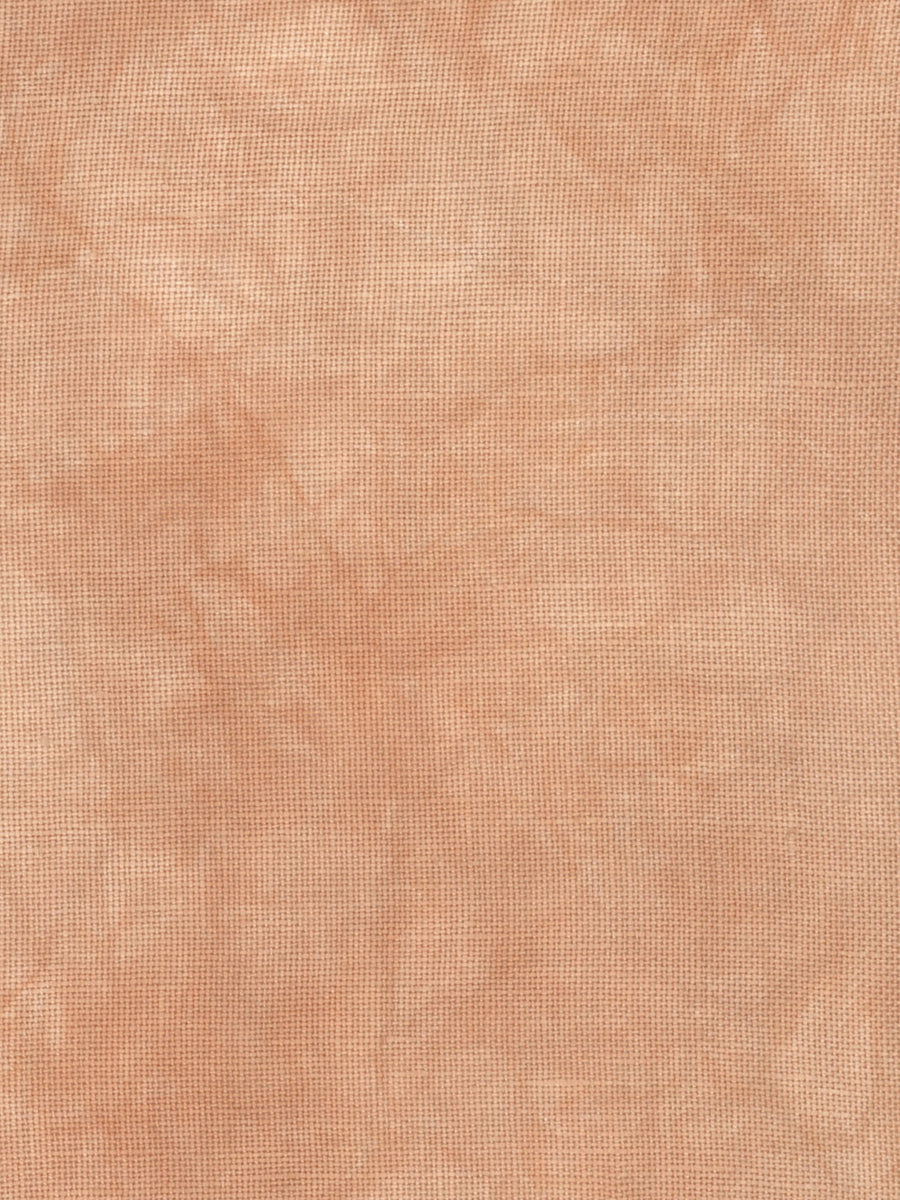 A close-up of a textured fabric or material swatch in a warm peachy beige color with subtle tonal variation.