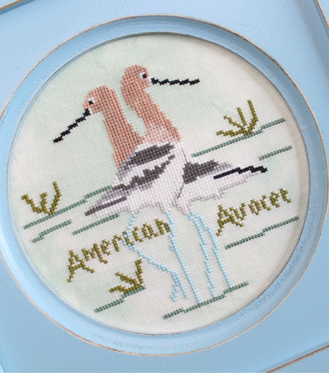 Embroidery of an American Avocet with a blue frame