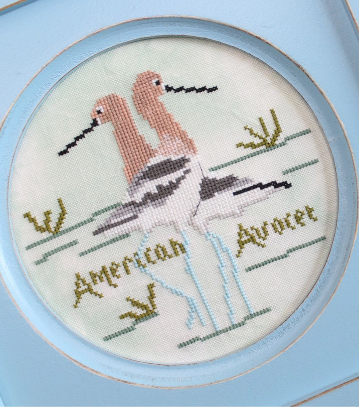Embroidery of an American Avocet with a blue frame