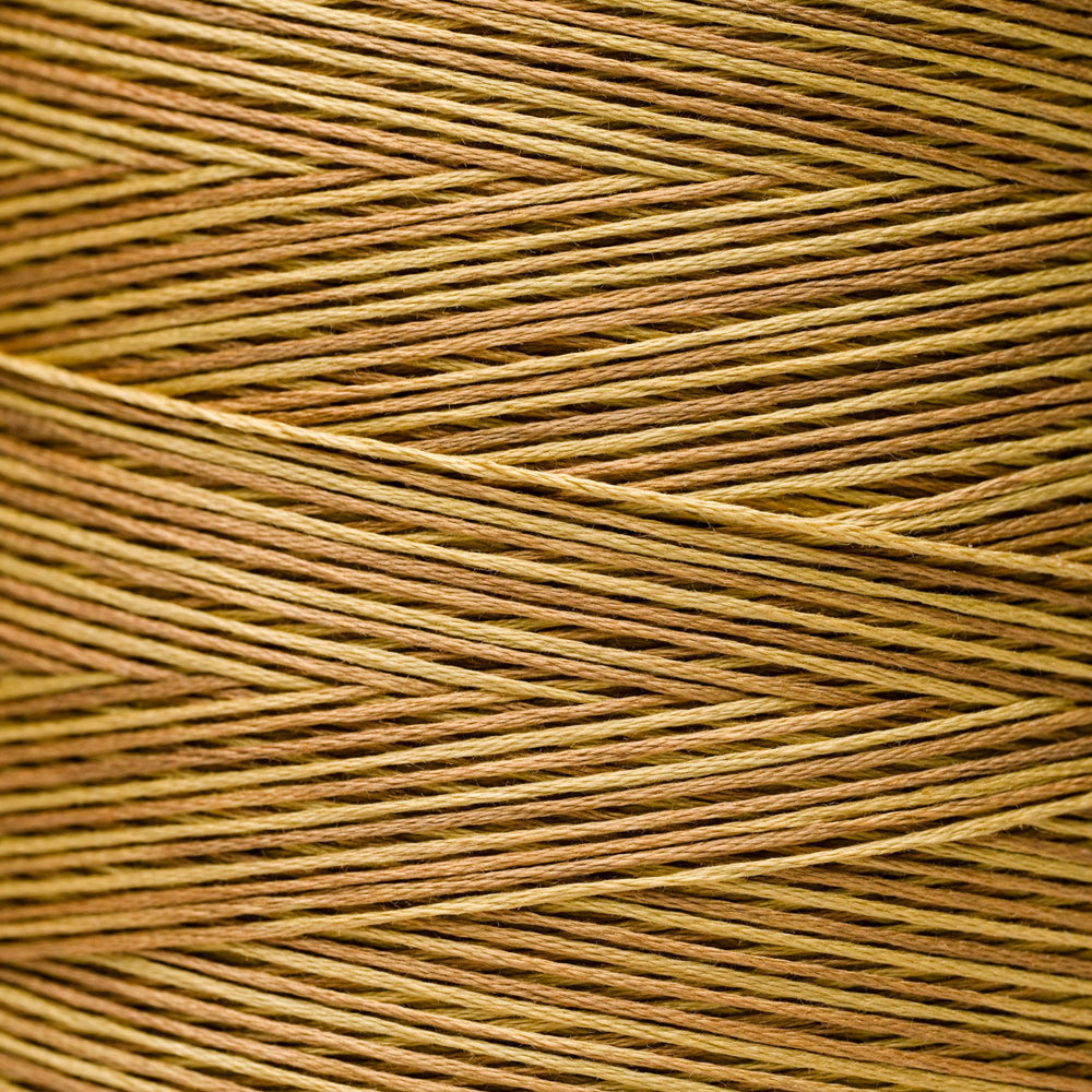 A close-up texture shot of braided embroidery thread in a warm tan and brown color.