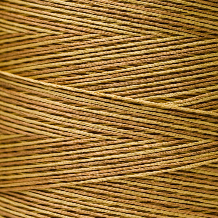 A close-up texture shot of braided embroidery thread in a warm tan and brown color.