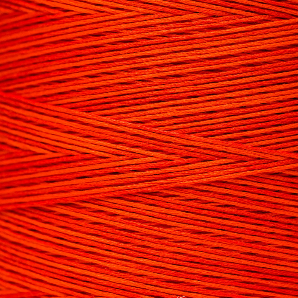 A close-up texture shot of bright orange-red yarn strands wound together, showing the fine thread details.
