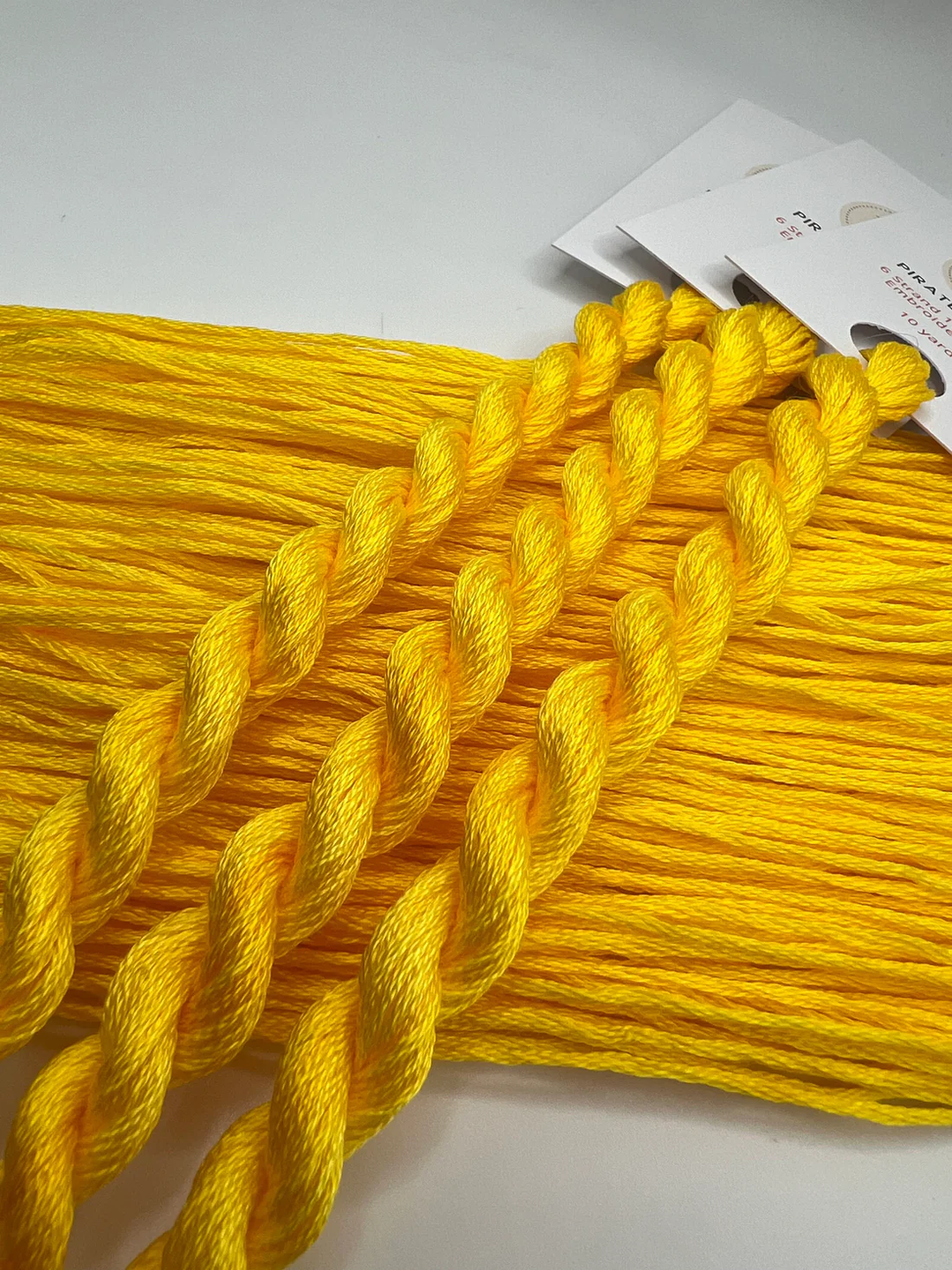 Yellow yarn skeins on a white background