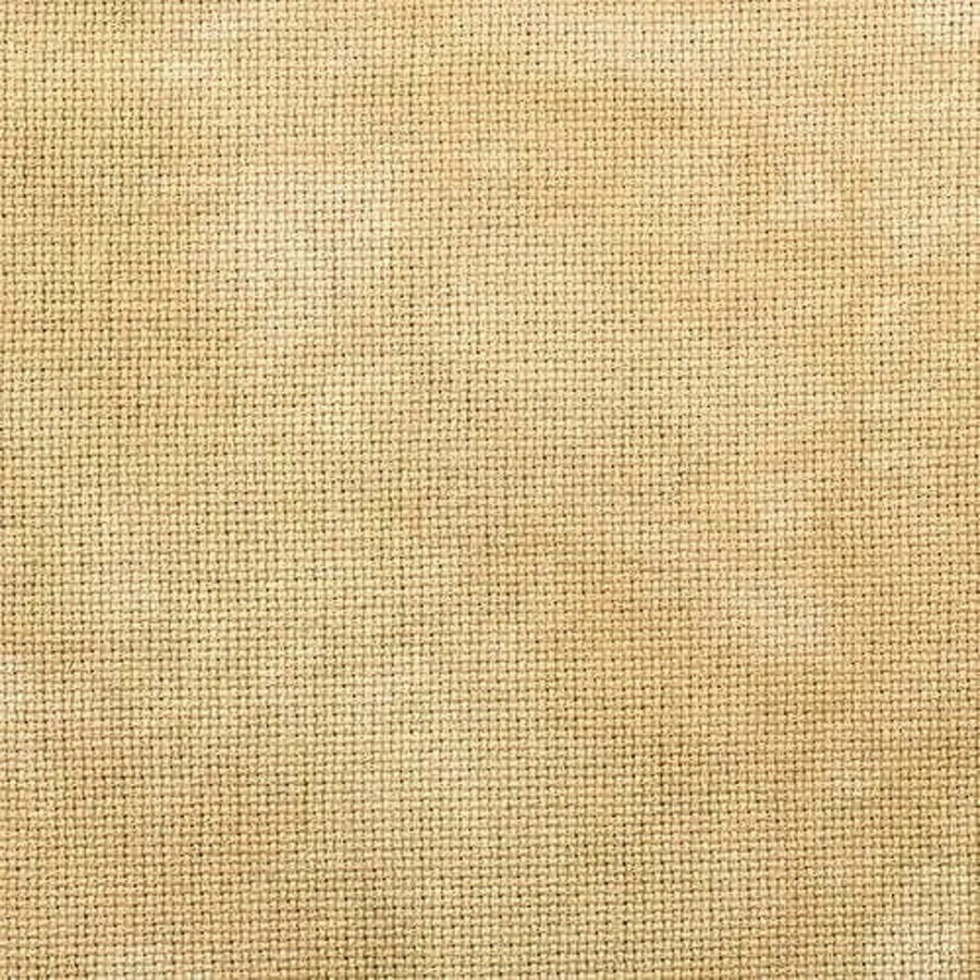 a rich caramel color yellow gold with mottling hand dyed by fiber on a whim for cross stitch projects 