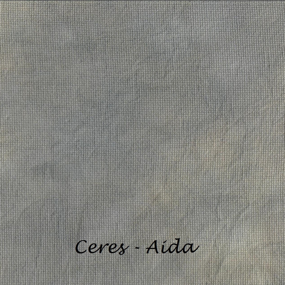 A close-up of a textured gray fabric or material swatch with the text 'Ceres - Aida' printed in black at the bottom center.