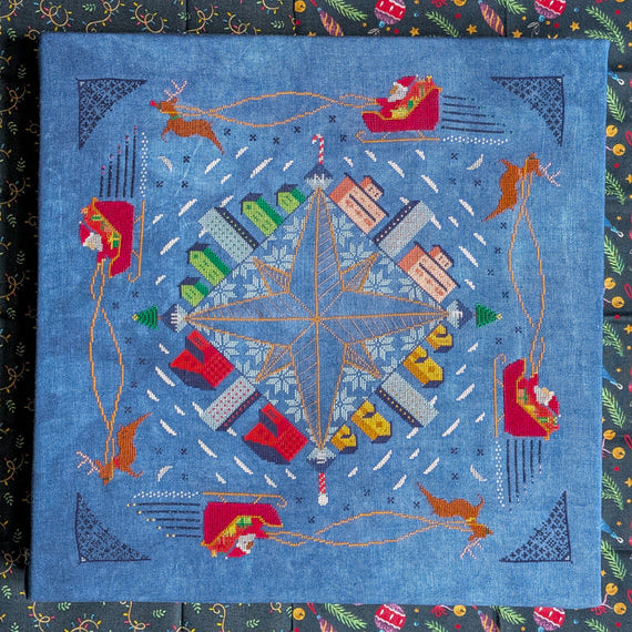 Decorative quilt with a star design and festive elements on a blue background