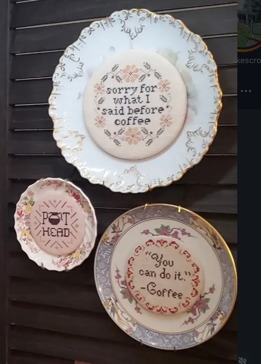 Three decorative plates with humorous sayings on a wooden surface