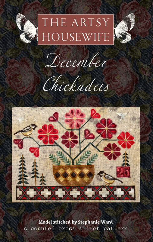 Cover of 'The Artsy Housewife December Chickadees' with cross-stitch pattern and floral design.