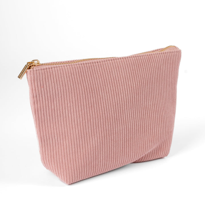 Pink ribbed pouch with a gold zipper on a white background
