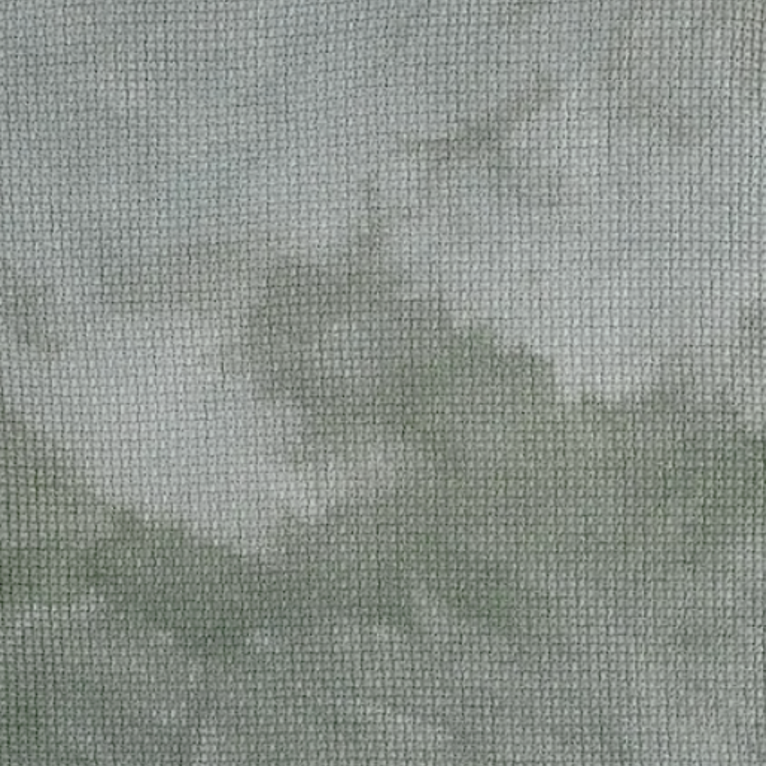 evergreen is a light but rich green color with a gray undertone and noticeable mottling hand dyed by fiber on a whim for cross stitch projects 