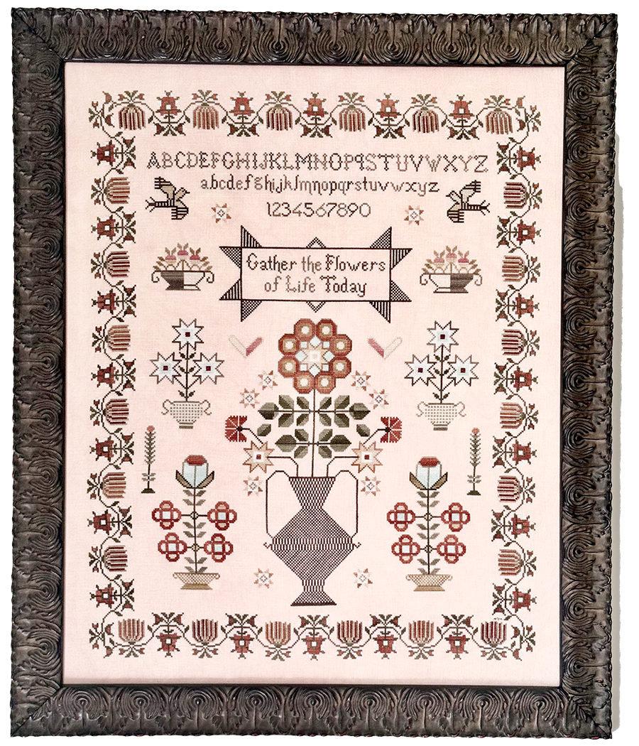 Decorative print with floral and geometric patterns, framed in brown.