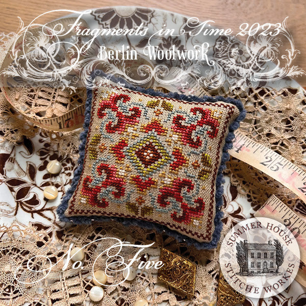 Decorative needlepoint pillow with intricate patterns on a textured surface with 'Summer House Stitchery Works' branding.