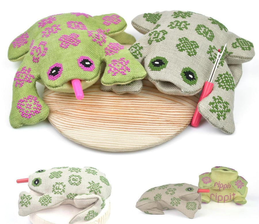 Set of frog-shaped pillow with a wooden platform and a small pink tool on a white background.