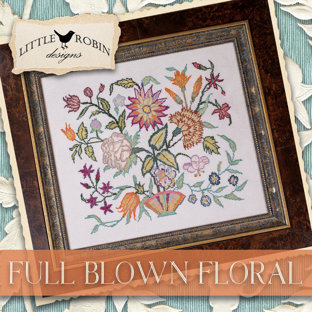 Framed cross-stitched floral design with 'Little Robin Designs' branding.