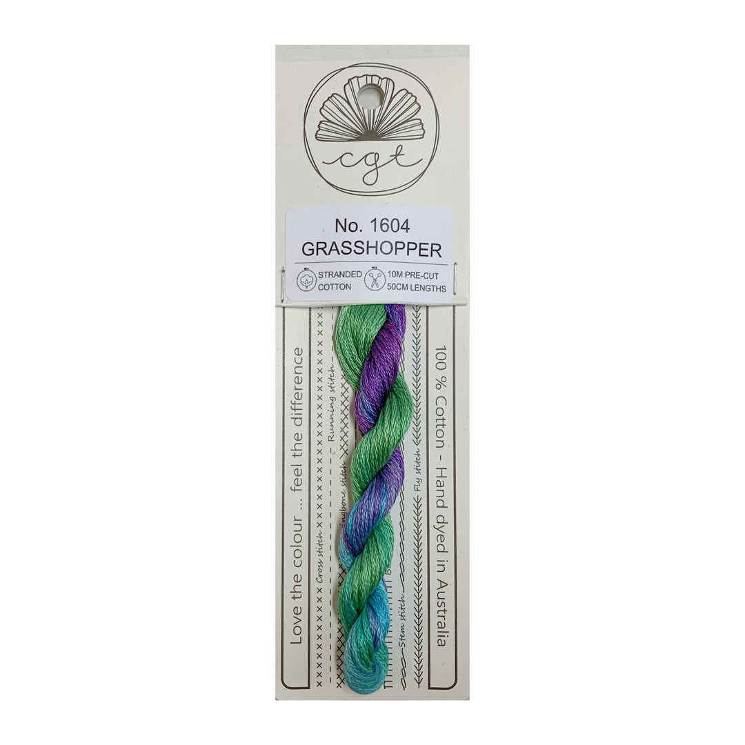 A skein of hand-dyed multicolor embroidery floss labeled 'Grasshopper' from Cottage Garden Threads on a cardboard retail packaging.